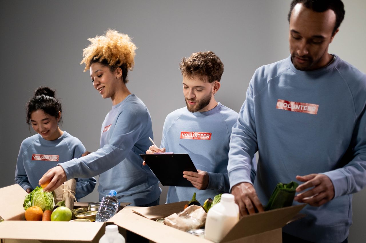 The Art of Drawing Readers In: Your attractive post title goes here Four diverse volunteers pack food donations with teamwork and dedication.